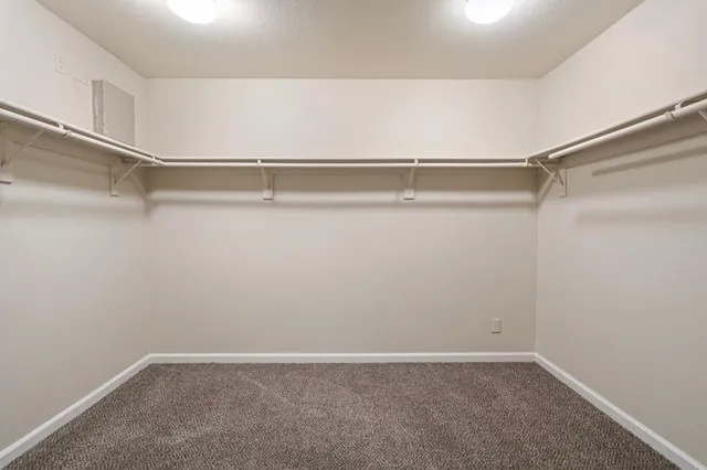 a kitchen with stainless steel appliances a stove a microwave and white cabinets