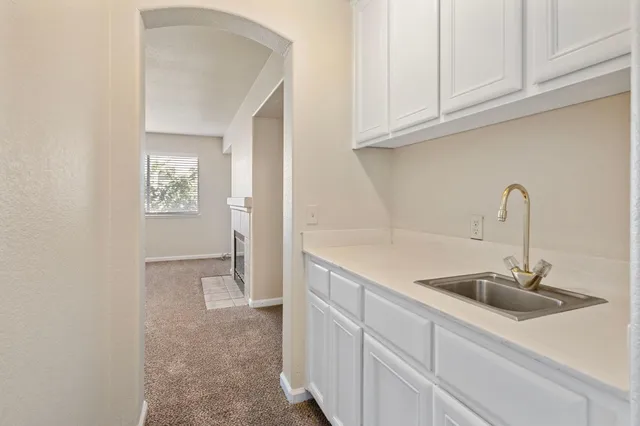 a view of a kitchen with white cabinets