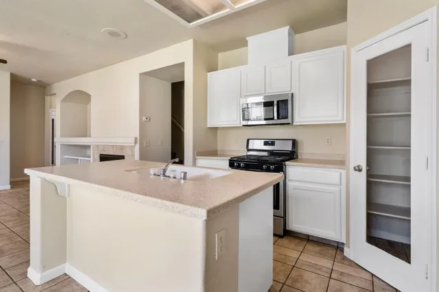 a kitchen with cabinets and a stove top oven