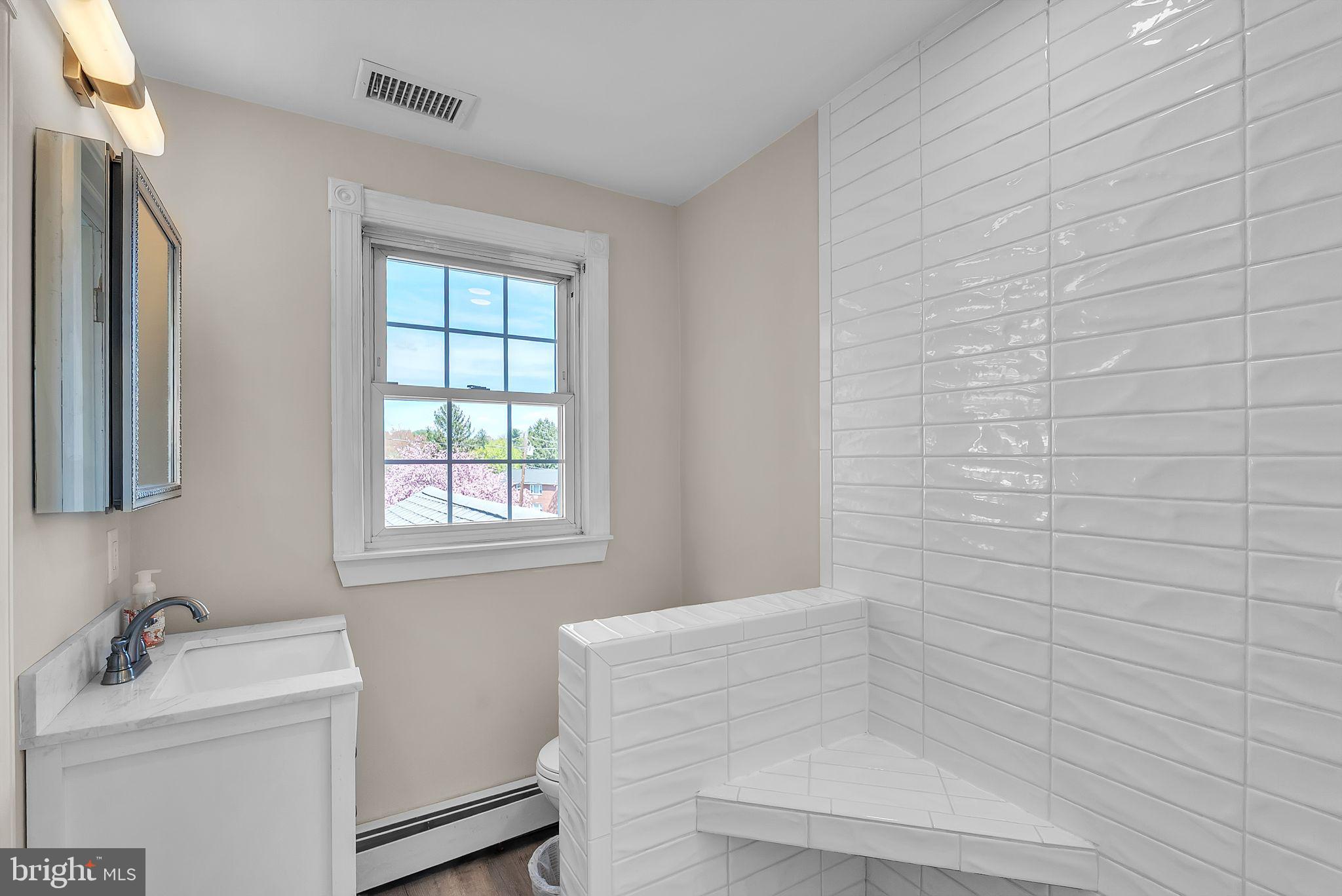 107 East Springfield Road Springfield, PA 19064 - Photo 15 of 40 a bathroom with a sink a toilet and tub