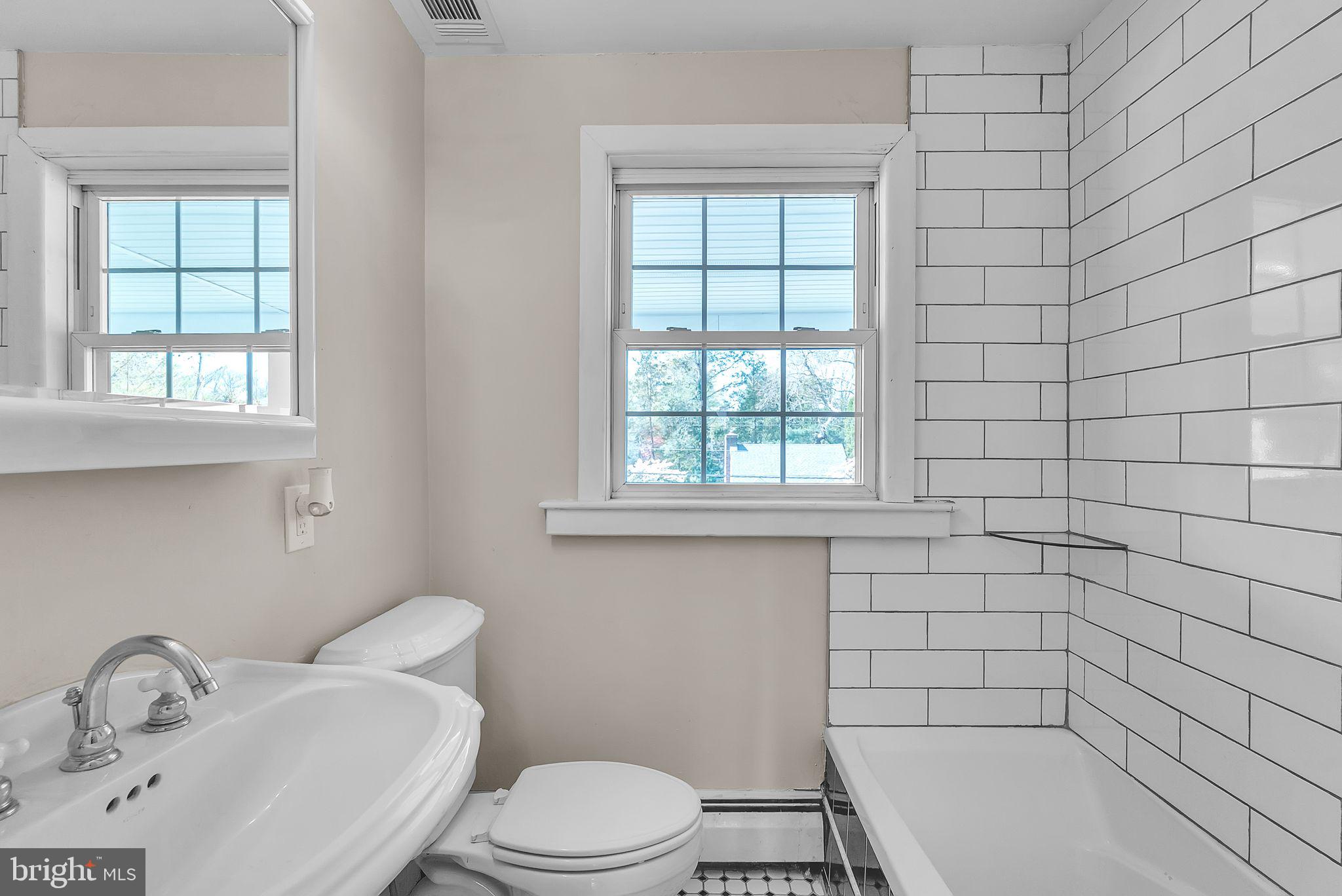 107 East Springfield Road Springfield, PA 19064 - Photo 16 of 40 a bathroom with a sink a toilet and window