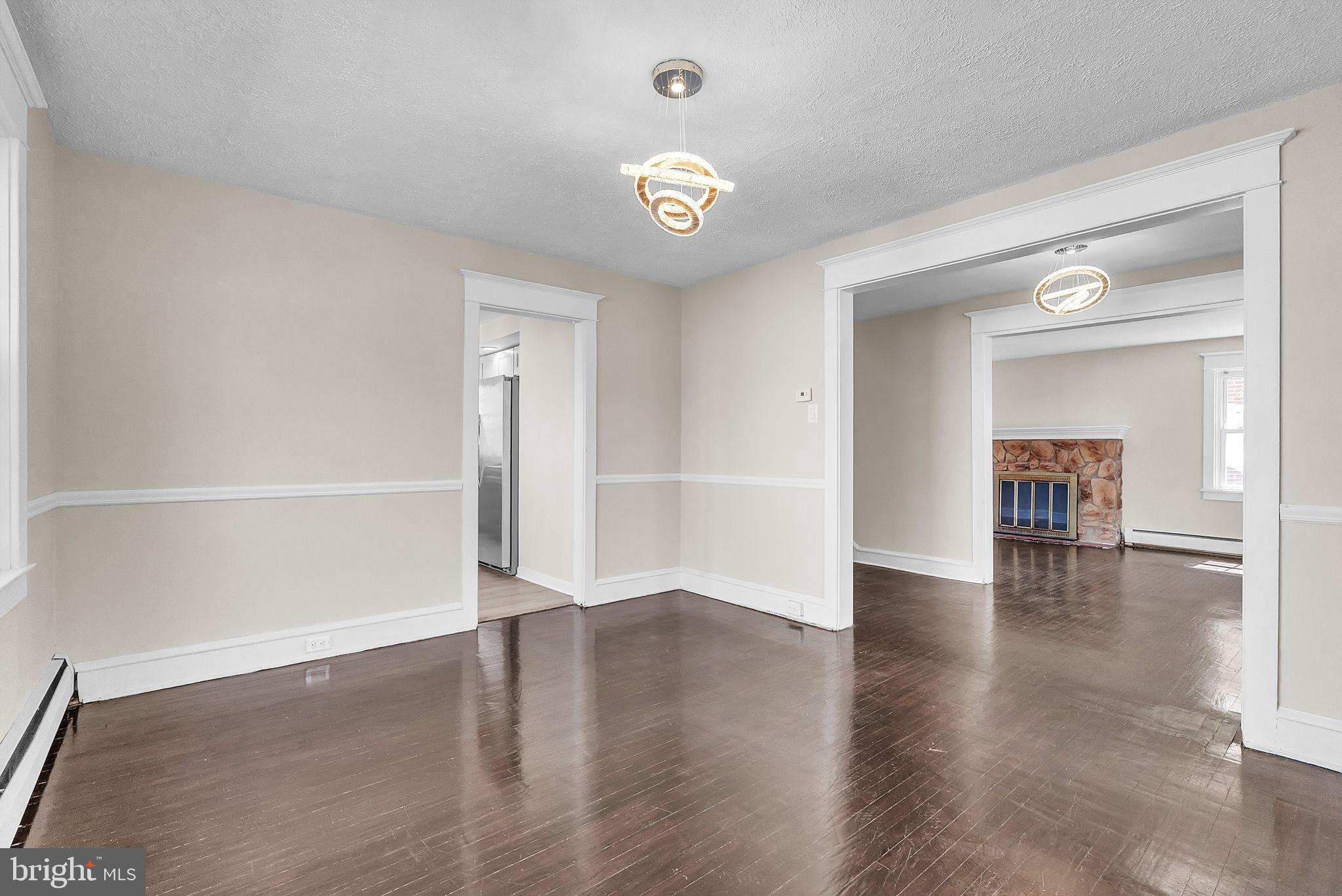 107 East Springfield Road Springfield, PA 19064 - Photo 21 of 40 a view of an empty room with window and wooden floor