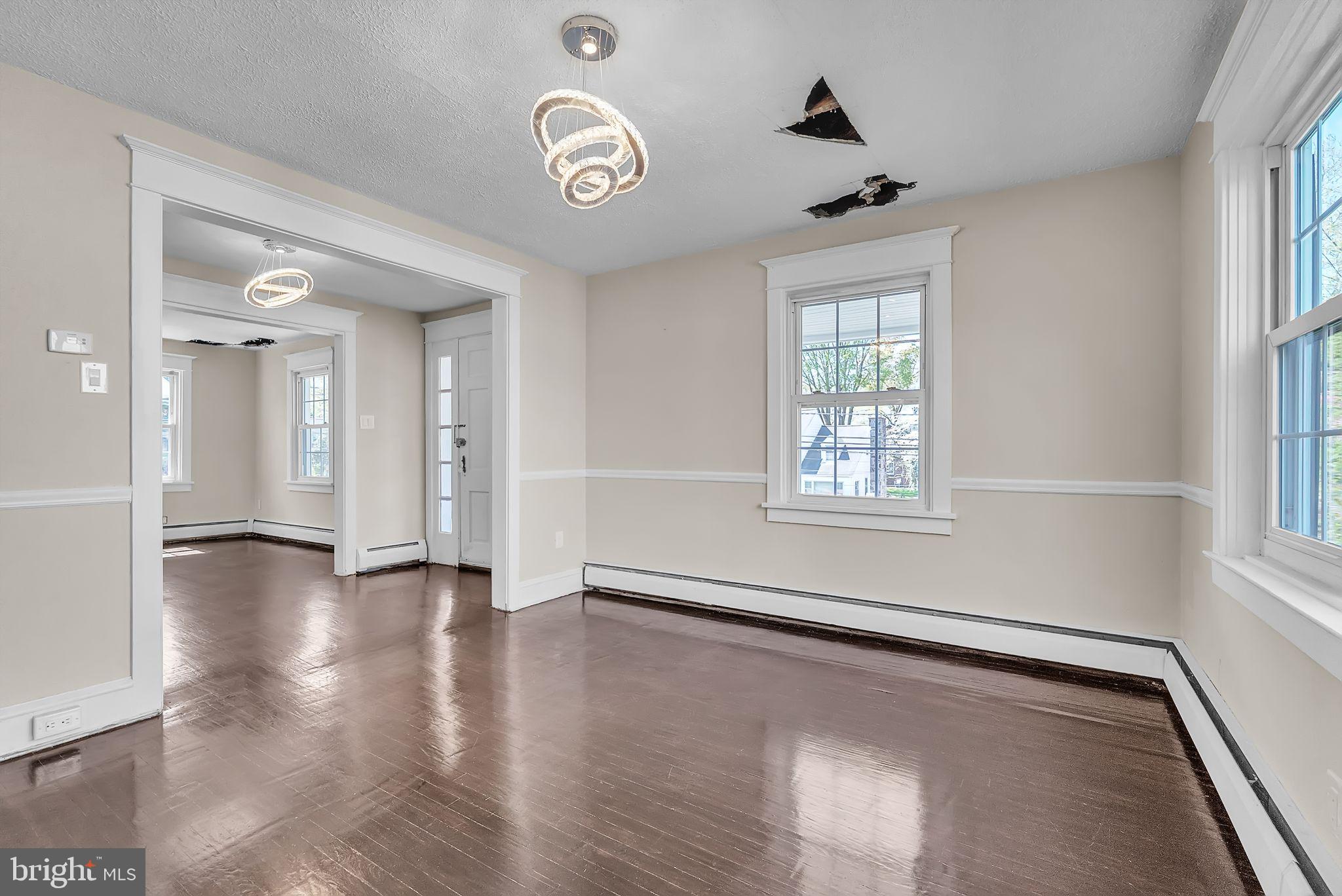 107 East Springfield Road Springfield, PA 19064 - Photo 23 of 40 an empty room with wooden floor and windows