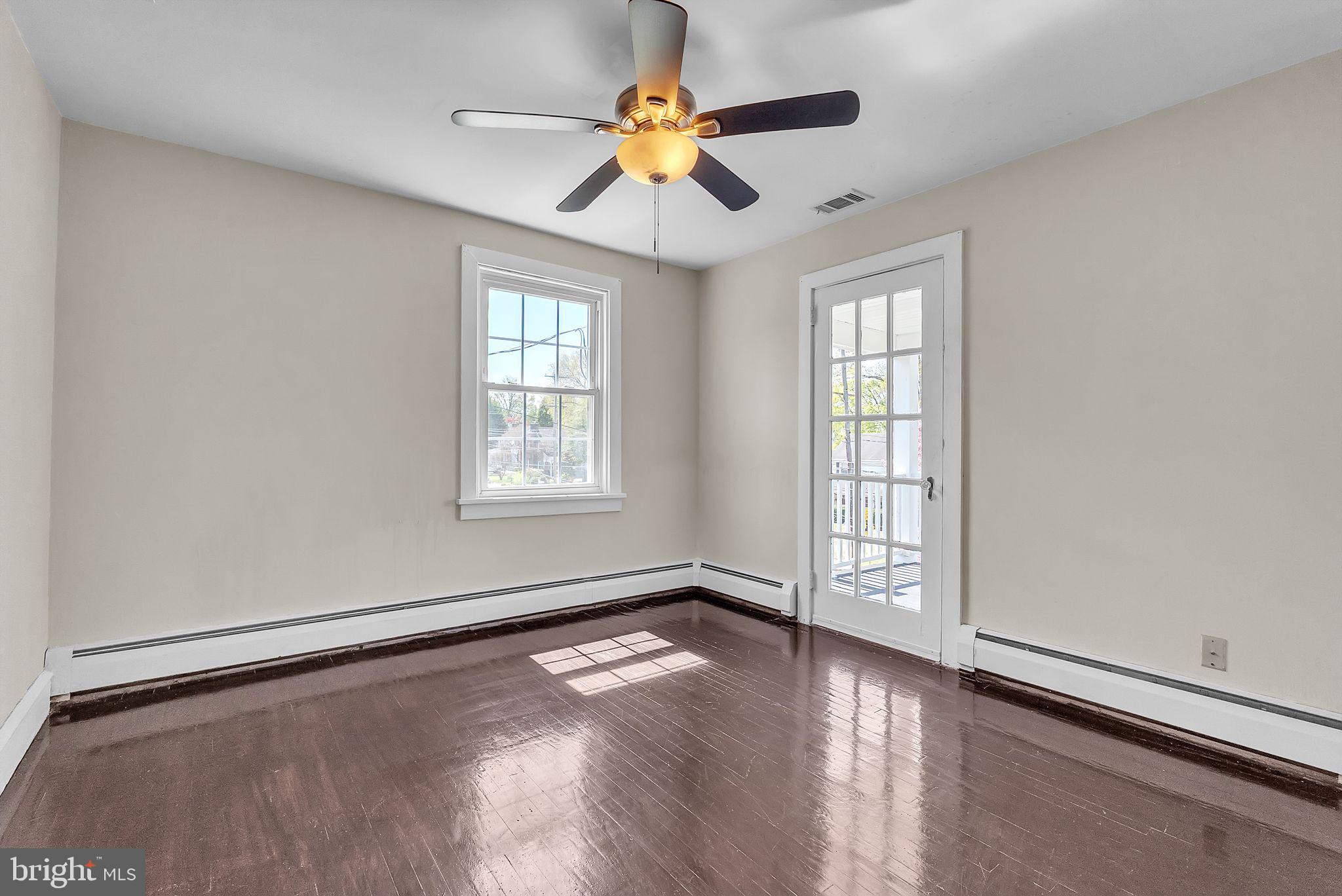 107 East Springfield Road Springfield, PA 19064 - Photo 24 of 40 a view of an empty room with window and wooden floor
