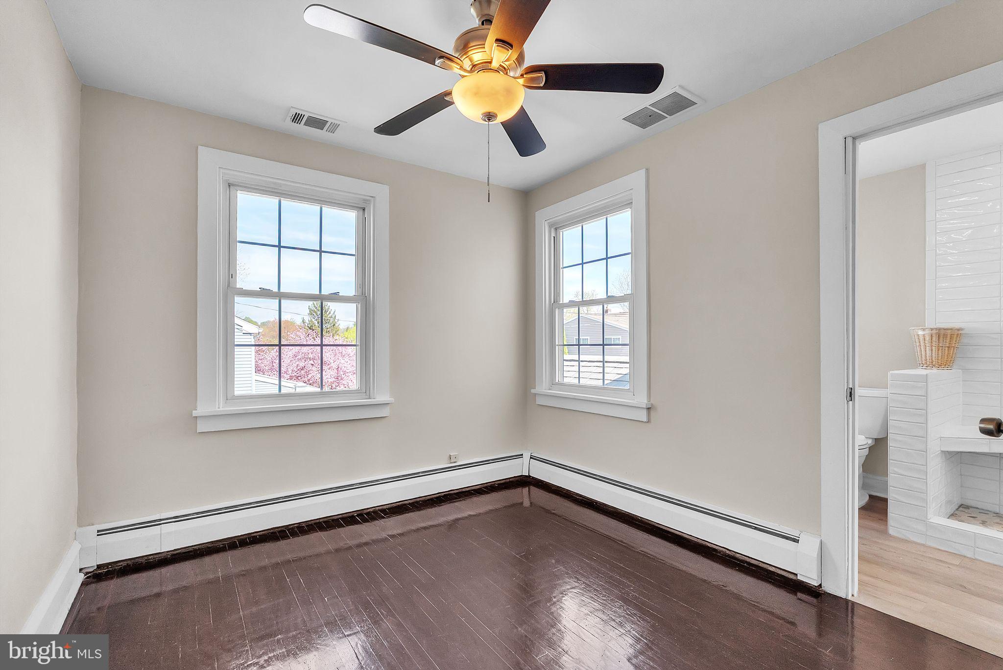 107 East Springfield Road Springfield, PA 19064 - Photo 27 of 40 a view of an empty room with window and wooden floor