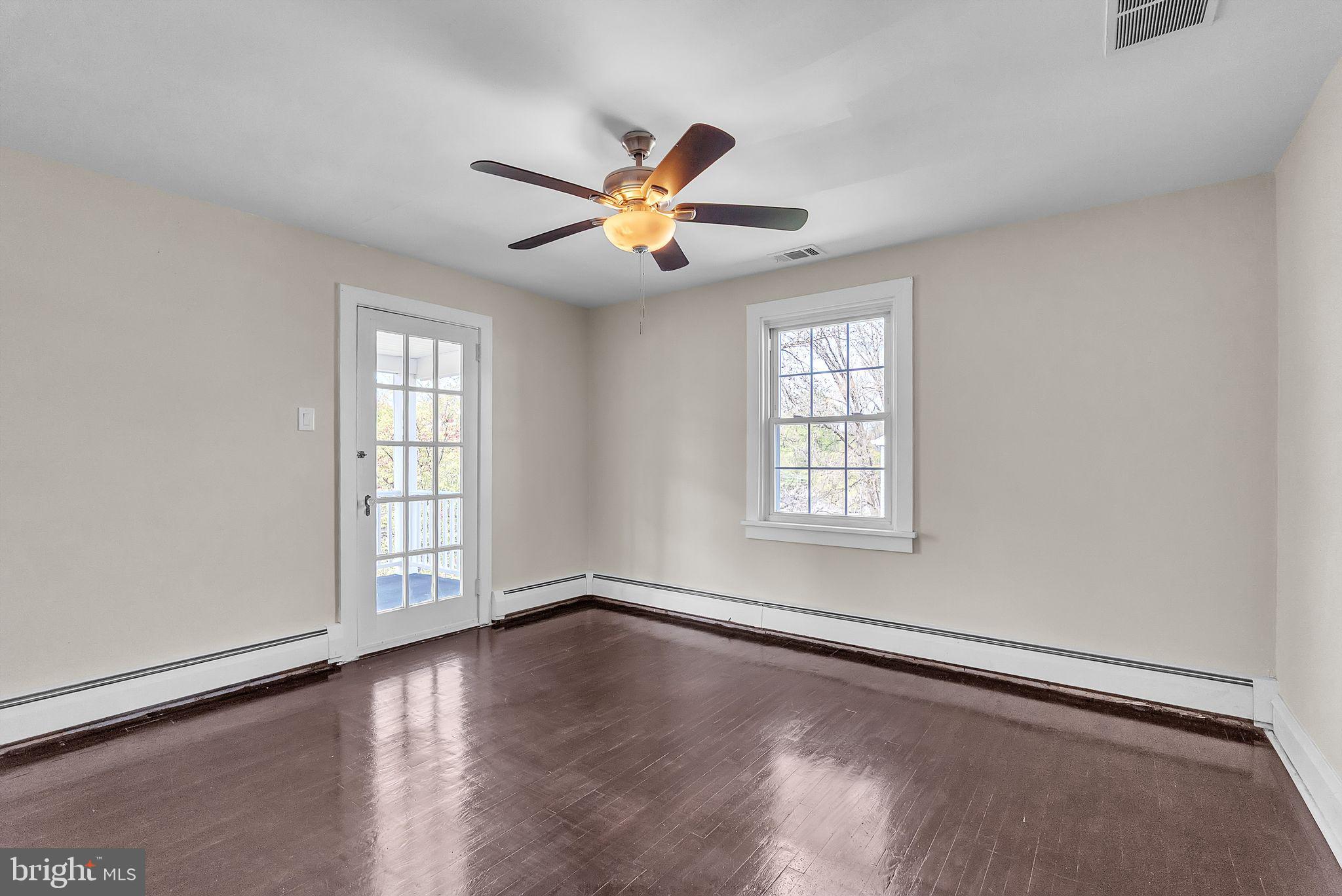 107 East Springfield Road Springfield, PA 19064 - Photo 28 of 40 a view of empty room with wooden floor and fan