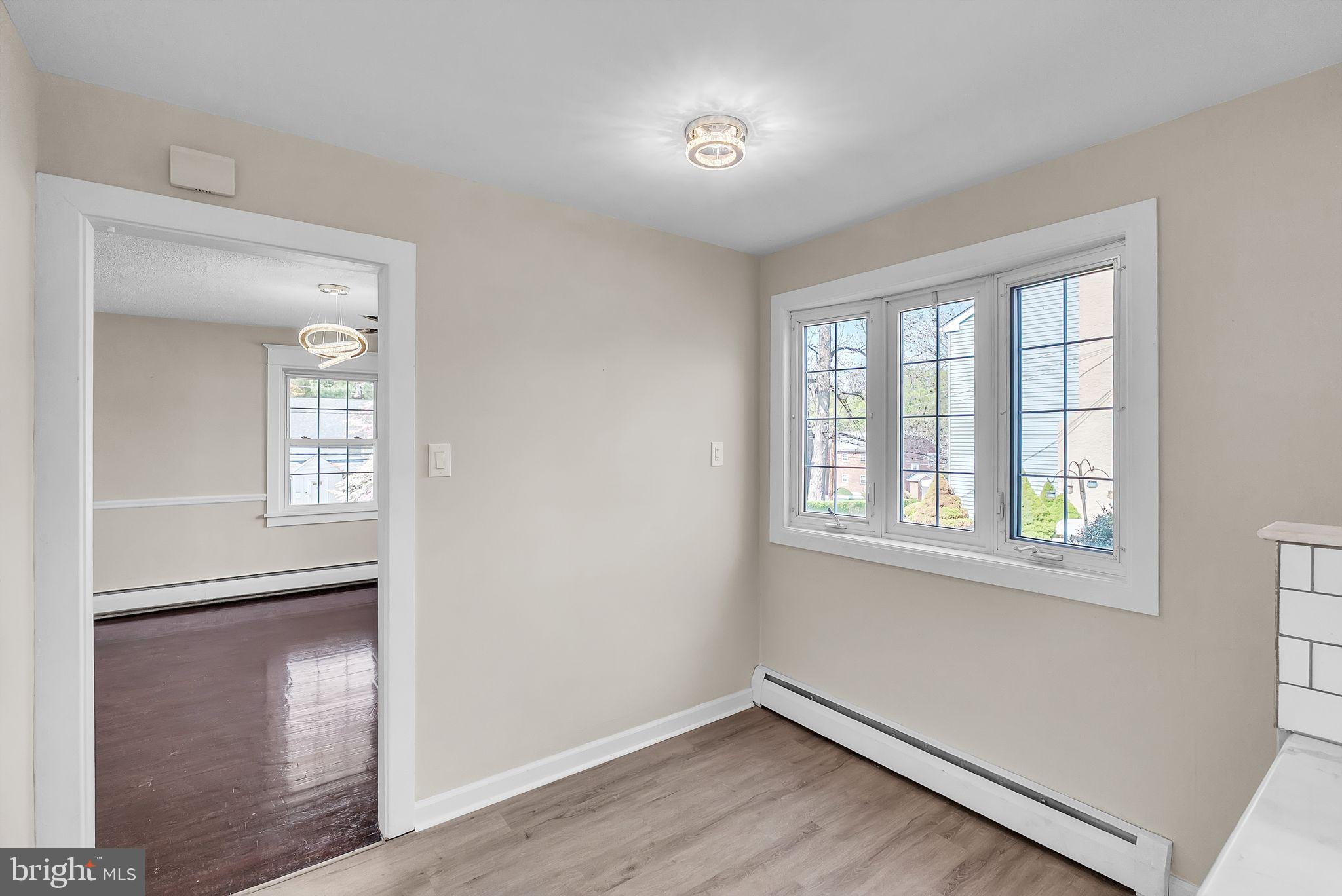 107 East Springfield Road Springfield, PA 19064 - Photo 30 of 40 a view of an empty room with wooden floor and a window