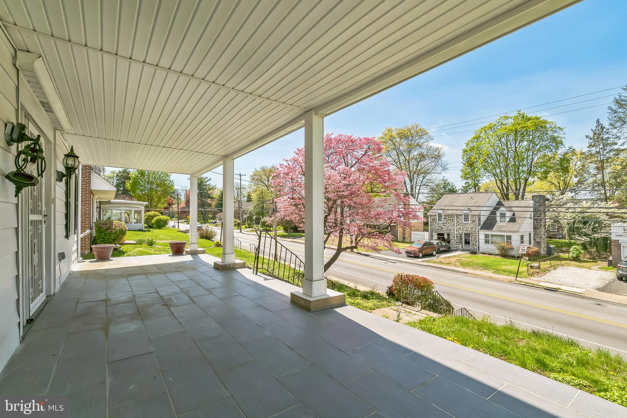 107 East Springfield Road Springfield, PA 19064 - Photo 5 of 40 a view of a patio with table and chairs and floor to ceiling window