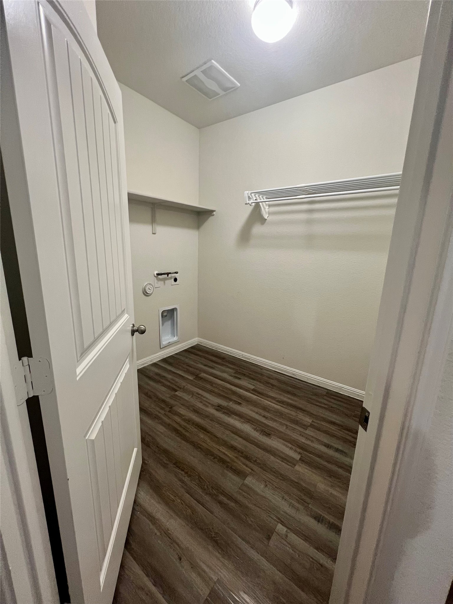 104 Moravia Road Georgetown, TX 78626 - Photo 18 of 36 Functional laundry room featuring sturdy wood flooring and convenient shelving.