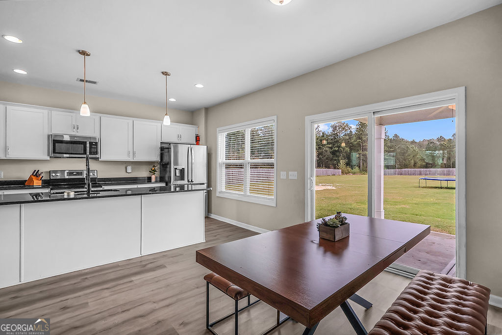 231 Caroline Way Guyton, GA 31312 - Photo 11 of 47 a view of kitchen with a table and chairs