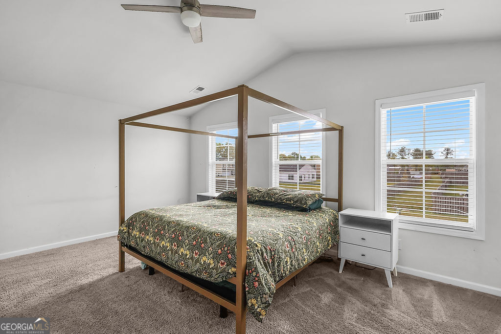 231 Caroline Way Guyton, GA 31312 - Photo 20 of 47 a bedroom with a bed and large window