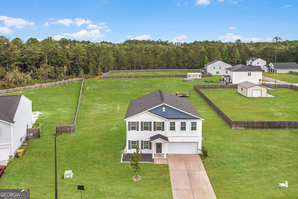 231 Caroline Way Guyton, GA 31312 - Photo 2 of 47 a view of a house with a big yard