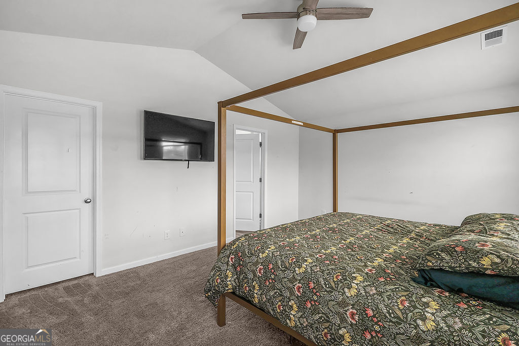 231 Caroline Way Guyton, GA 31312 - Photo 21 of 47 a bedroom with a bed and a flat screen tv