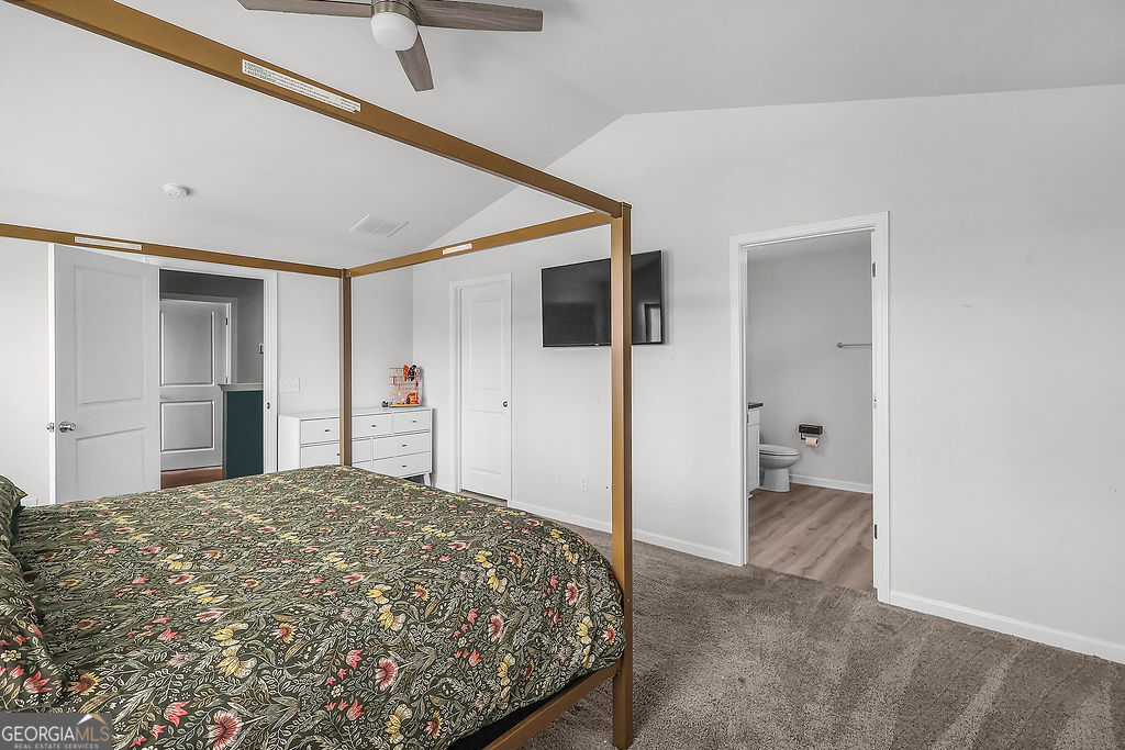 231 Caroline Way Guyton, GA 31312 - Photo 22 of 47 a bedroom with a bed and a view of bathroom