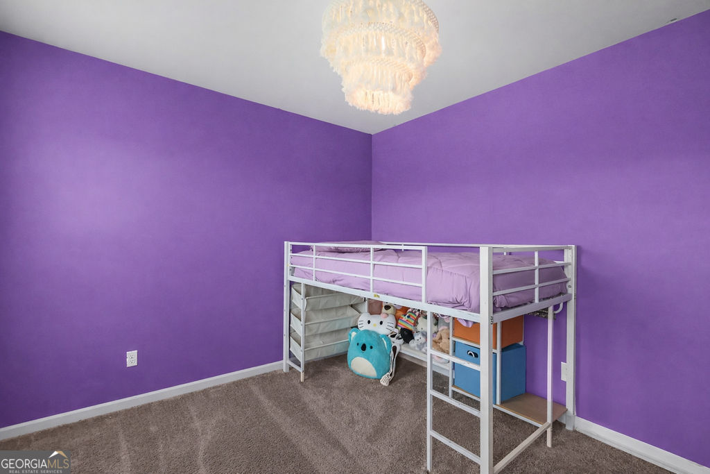 231 Caroline Way Guyton, GA 31312 - Photo 27 of 47 a bedroom with a bed and a window