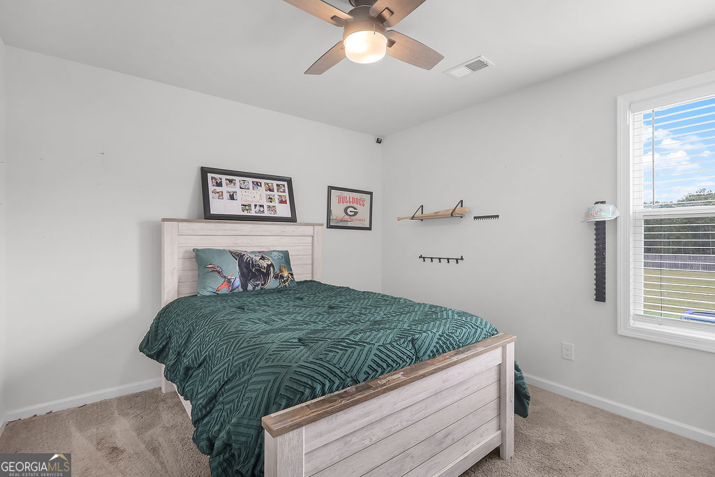 231 Caroline Way Guyton, GA 31312 - Photo 31 of 47 a bedroom with a bed and a window