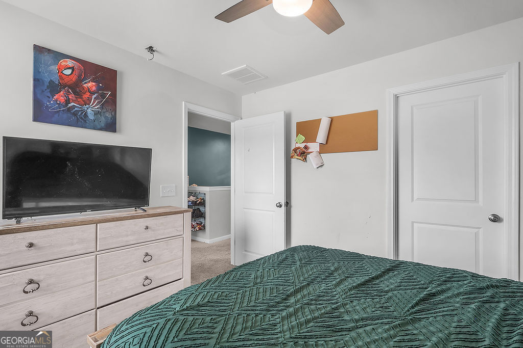 231 Caroline Way Guyton, GA 31312 - Photo 33 of 47 a bedroom with a bed and a flat screen tv