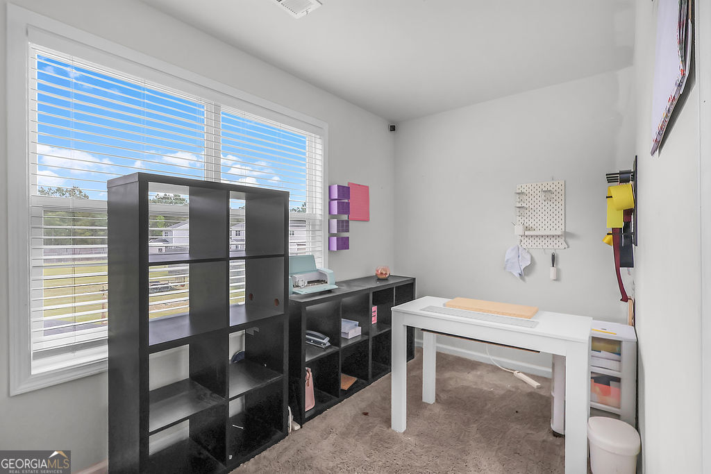 231 Caroline Way Guyton, GA 31312 - Photo 35 of 47 a room with furniture a rug and a table