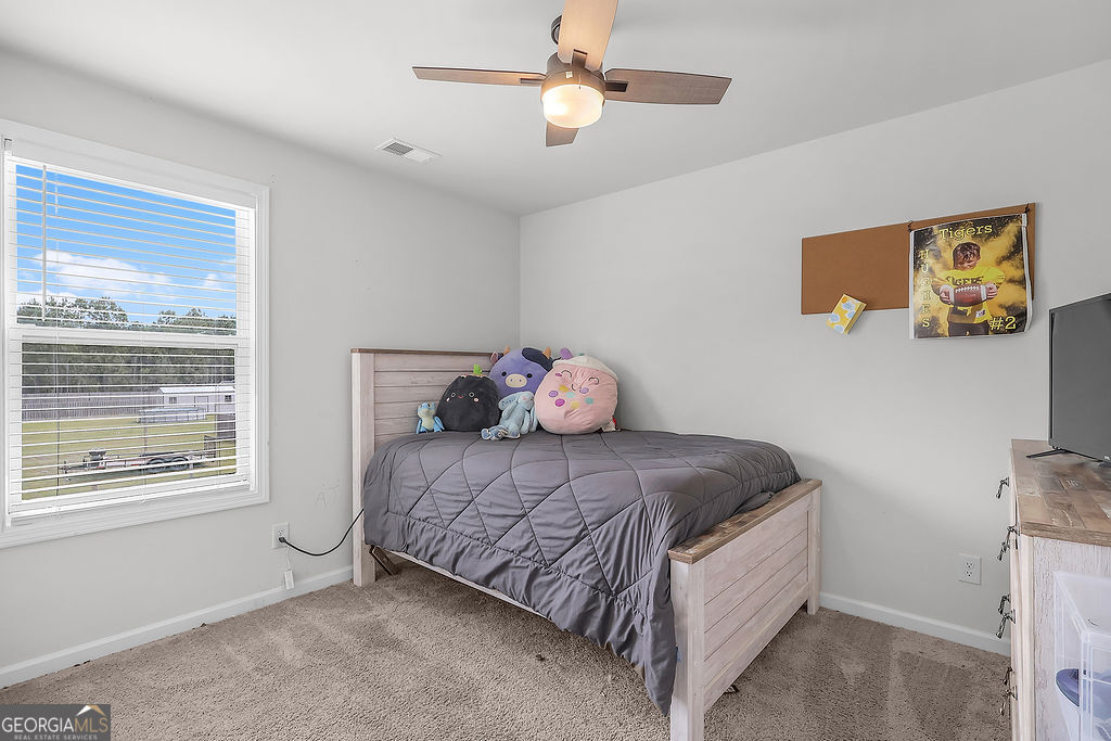 231 Caroline Way Guyton, GA 31312 - Photo 37 of 47 a bedroom with a bed and window