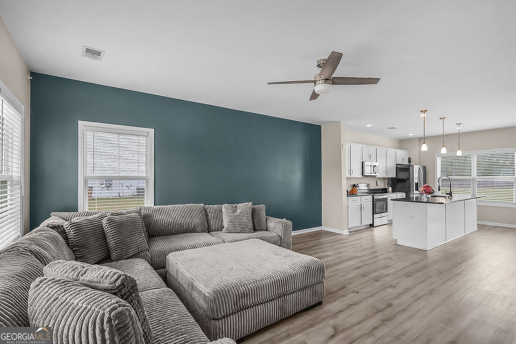 231 Caroline Way Guyton, GA 31312 - Photo 4 of 47 a living room with furniture and kitchen view