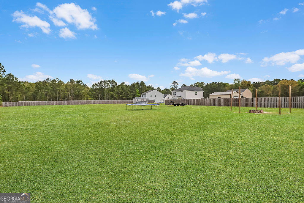 231 Caroline Way Guyton, GA 31312 - Photo 43 of 47 a view of yard with swimming pool and green space
