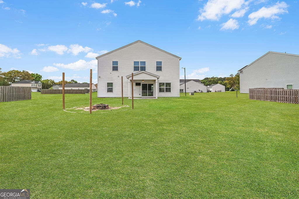 231 Caroline Way Guyton, GA 31312 - Photo 45 of 47 a front view of a house with garden