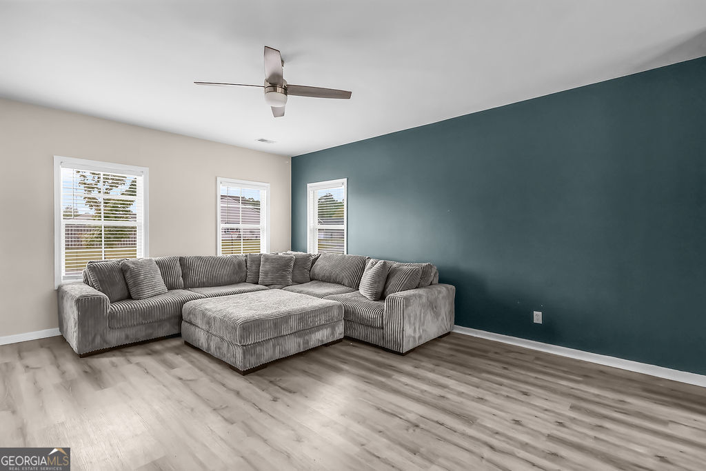 231 Caroline Way Guyton, GA 31312 - Photo 5 of 47 a living room with furniture and a window
