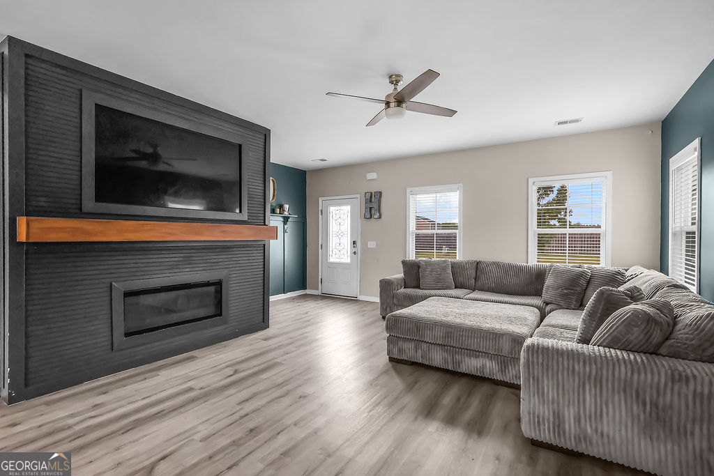 231 Caroline Way Guyton, GA 31312 - Photo 7 of 47 a living room with furniture and a fireplace