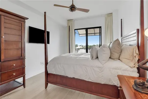 a bedroom with a bed window and dresser