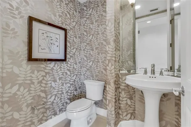 a bathroom with a toilet and a sink