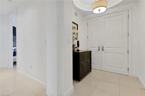 a view of an entryway with table and mirror