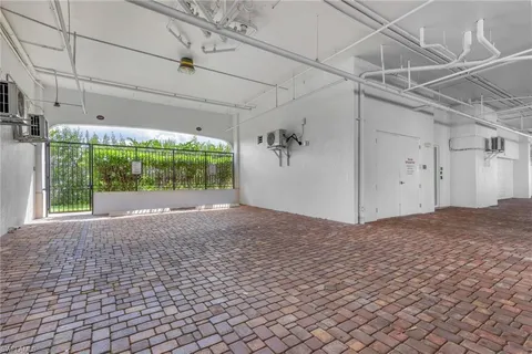 a street sign on a sidewalk next to a building