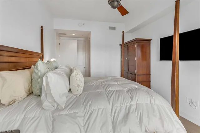 a view of a balcony with wooden floor & fence