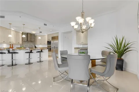 a view of a dining room kitchen with furniture and a chandelier