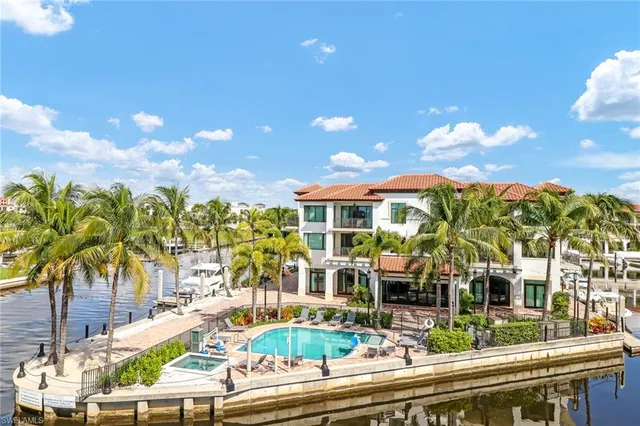 a view of a house with swimming pool and sitting area