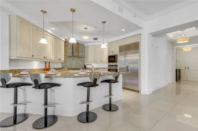 a kitchen with cabinets and chairs