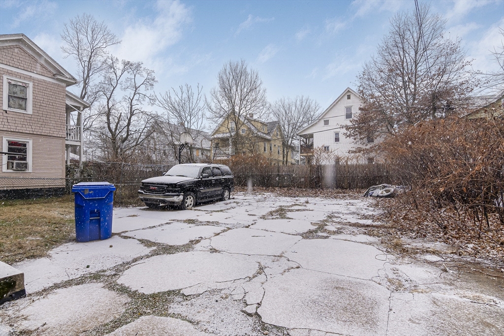 62 Kenyon Street Springfield, MA 01109 - Photo 19 of 19 a white house that has a tree in front of it
