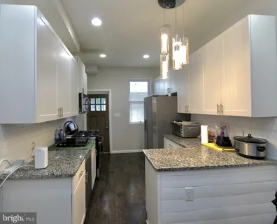 a kitchen with stainless steel appliances granite countertop a sink refrigerator and microwave