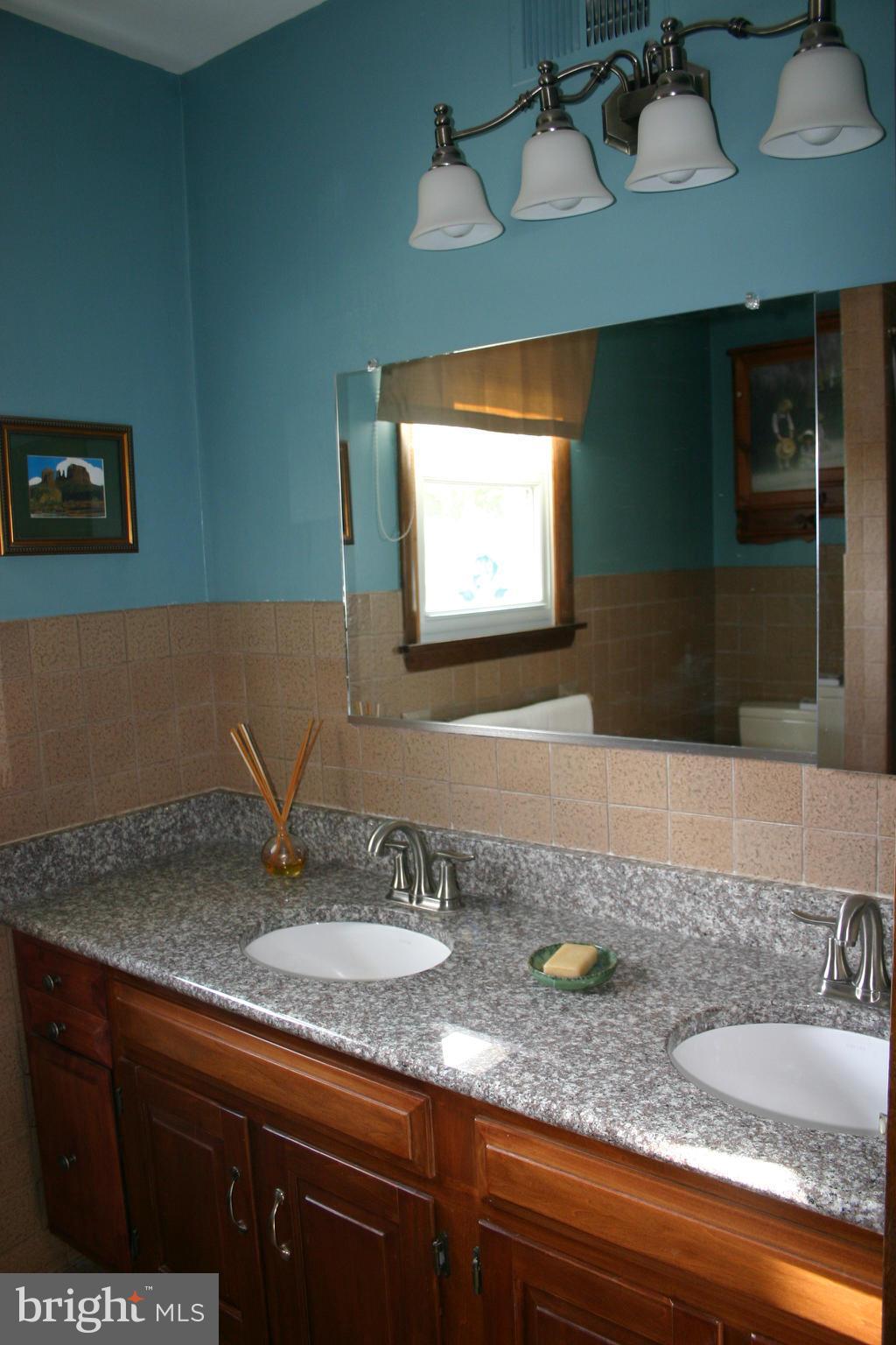 14003 Glen High Road Baldwin, MD 21013 - Photo 11 of 26 a bathroom with a sink and a mirror