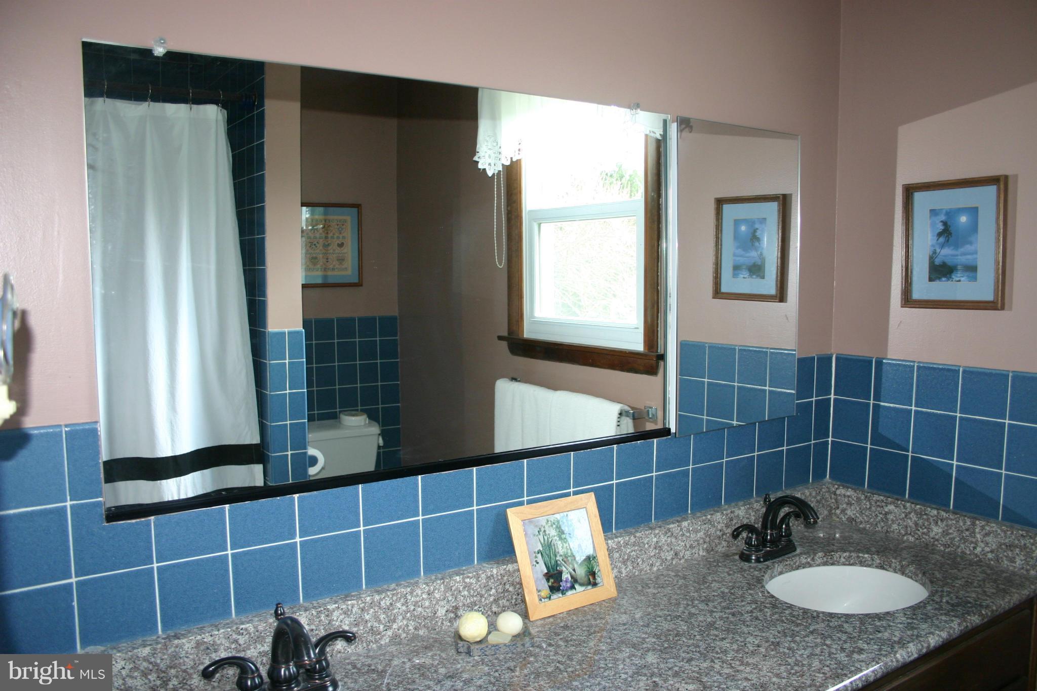 14003 Glen High Road Baldwin, MD 21013 - Photo 15 of 26 a bathroom with a granite countertop sink and a mirror