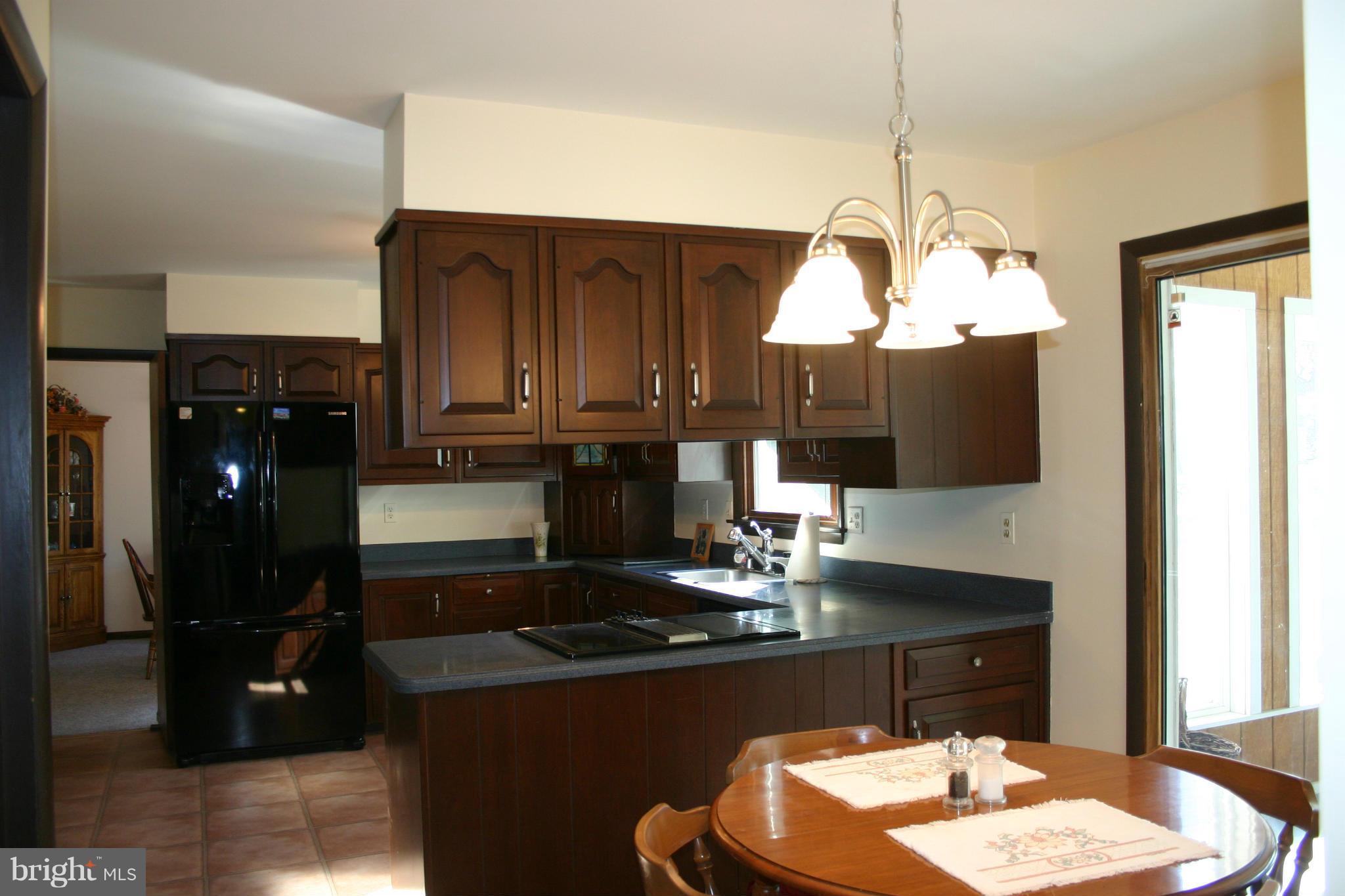14003 Glen High Road Baldwin, MD 21013 - Photo 5 of 26 a kitchen with a sink refrigerator and cabinets
