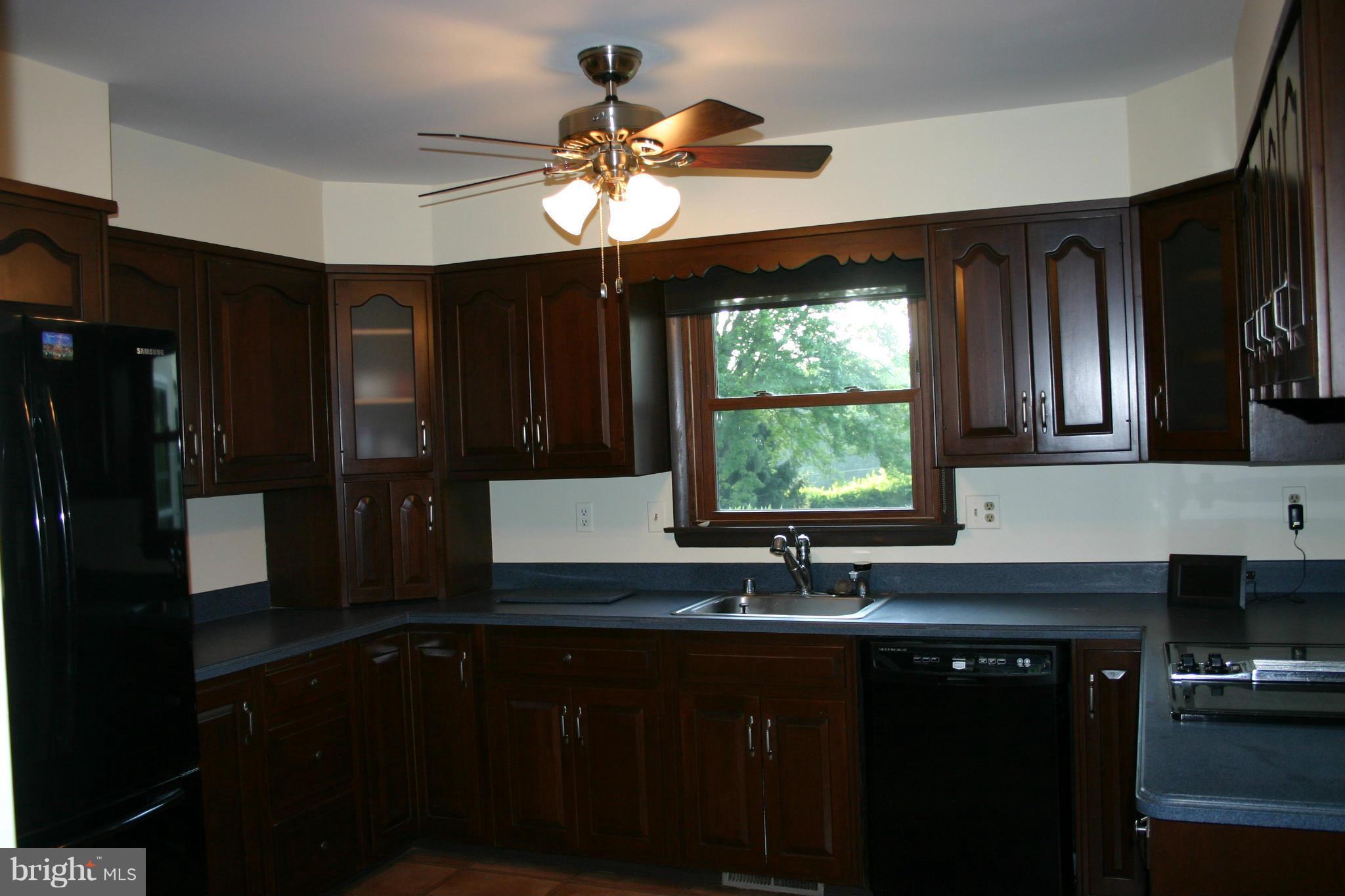 14003 Glen High Road Baldwin, MD 21013 - Photo 7 of 26 a kitchen with a sink cabinets and window