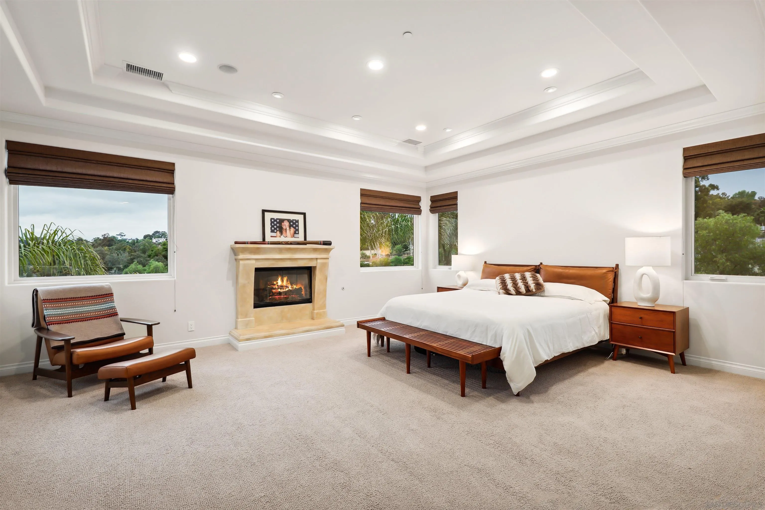 3055 Brookside Lane Encinitas, CA 92024 - Photo 22 of 64 a spacious bedroom with a bed and a fireplace