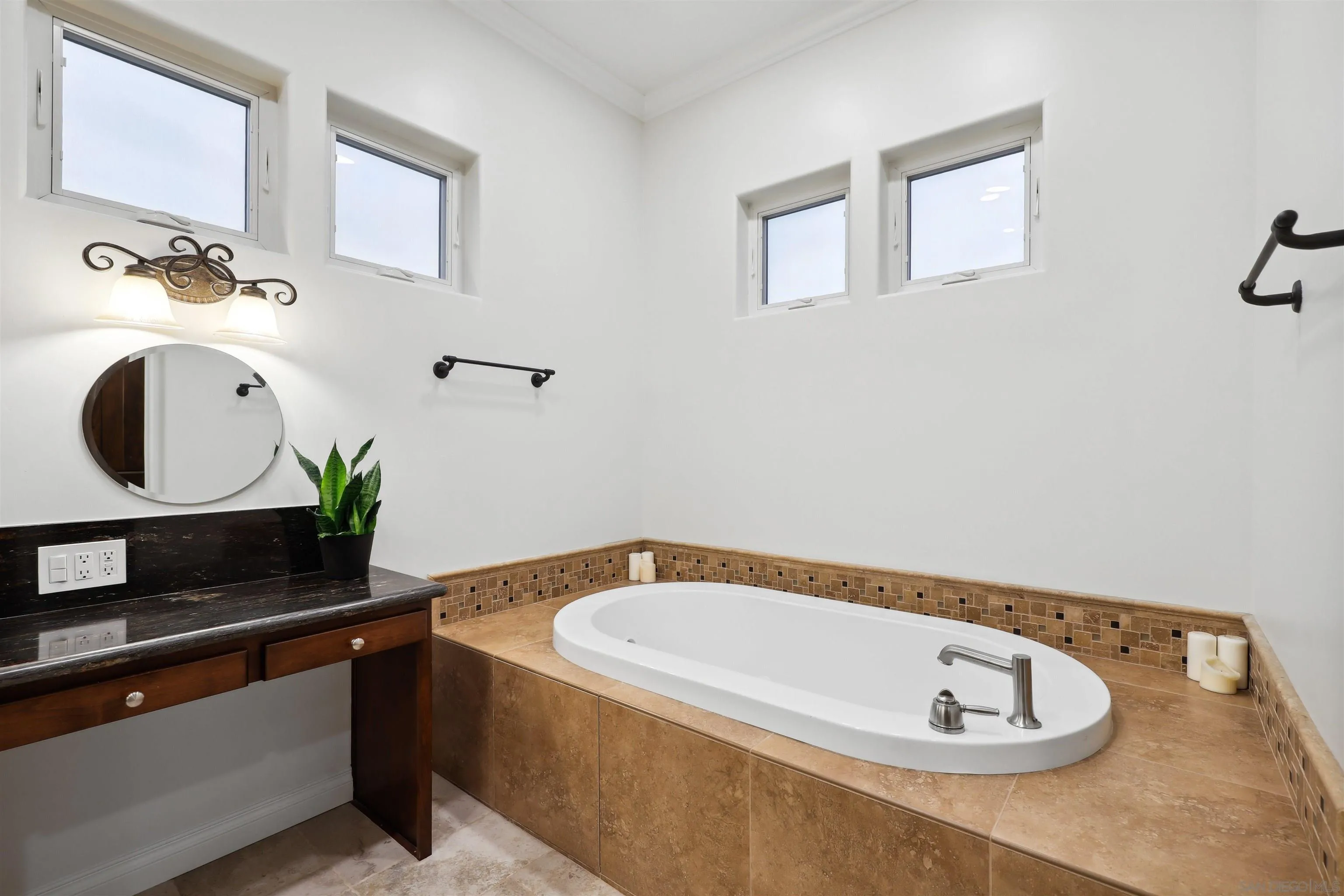 3055 Brookside Lane Encinitas, CA 92024 - Photo 26 of 64 a bathroom with a tub sink and mirror
