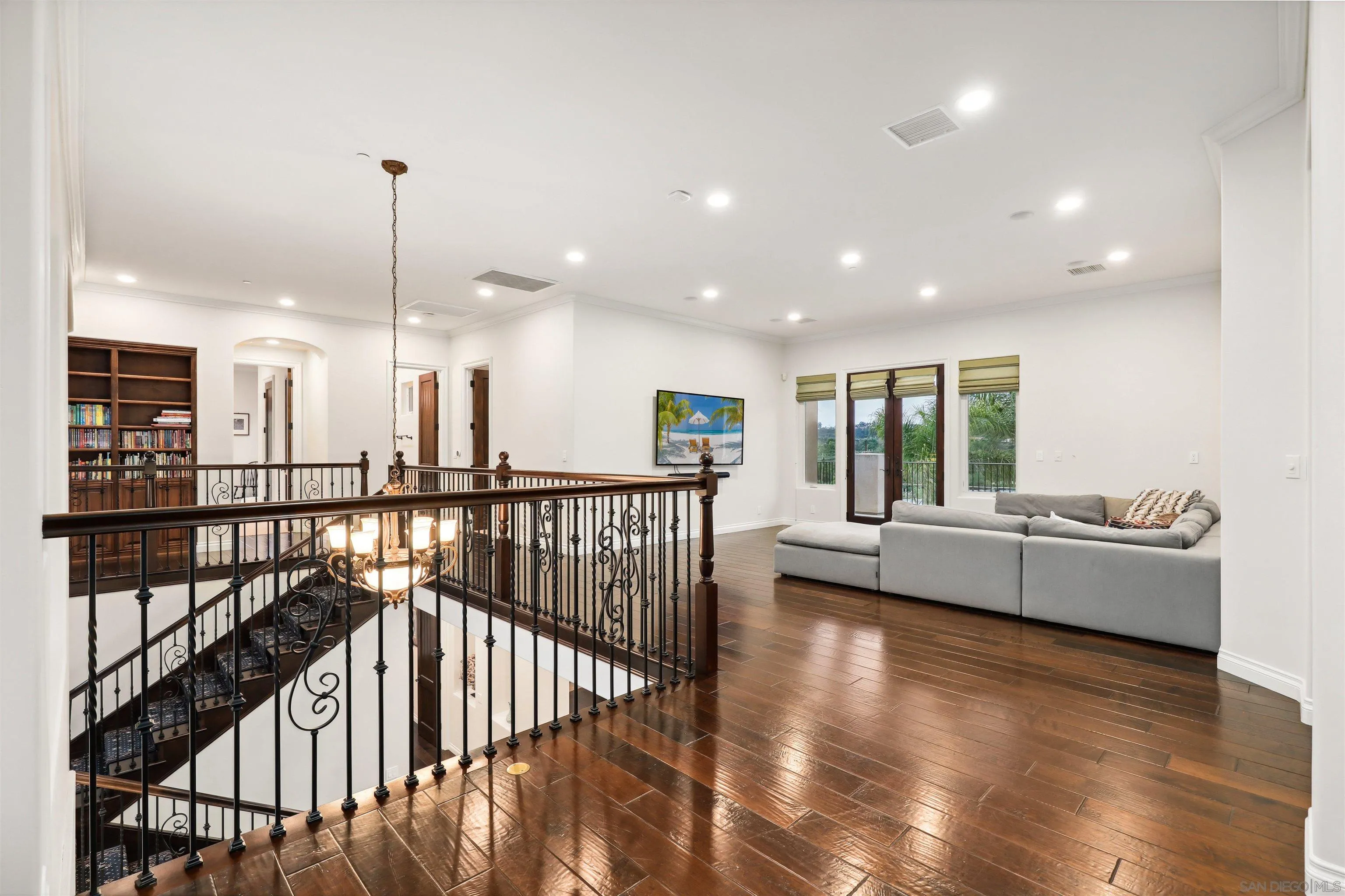 3055 Brookside Lane Encinitas, CA 92024 - Photo 28 of 64 a view of a living room and kitchen with furniture wooden floor and windows