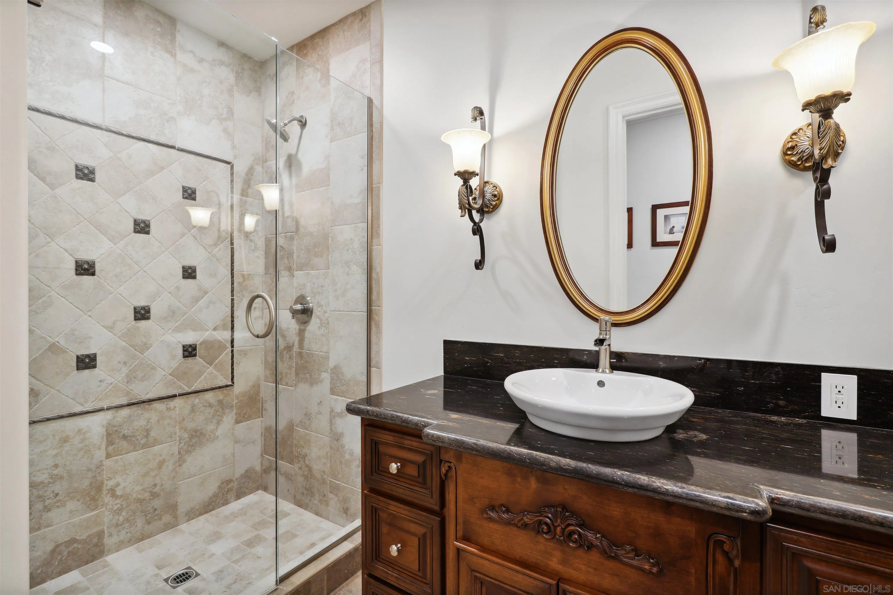 3055 Brookside Lane Encinitas, CA 92024 - Photo 34 of 64 a bathroom with a sink a mirror and a shower