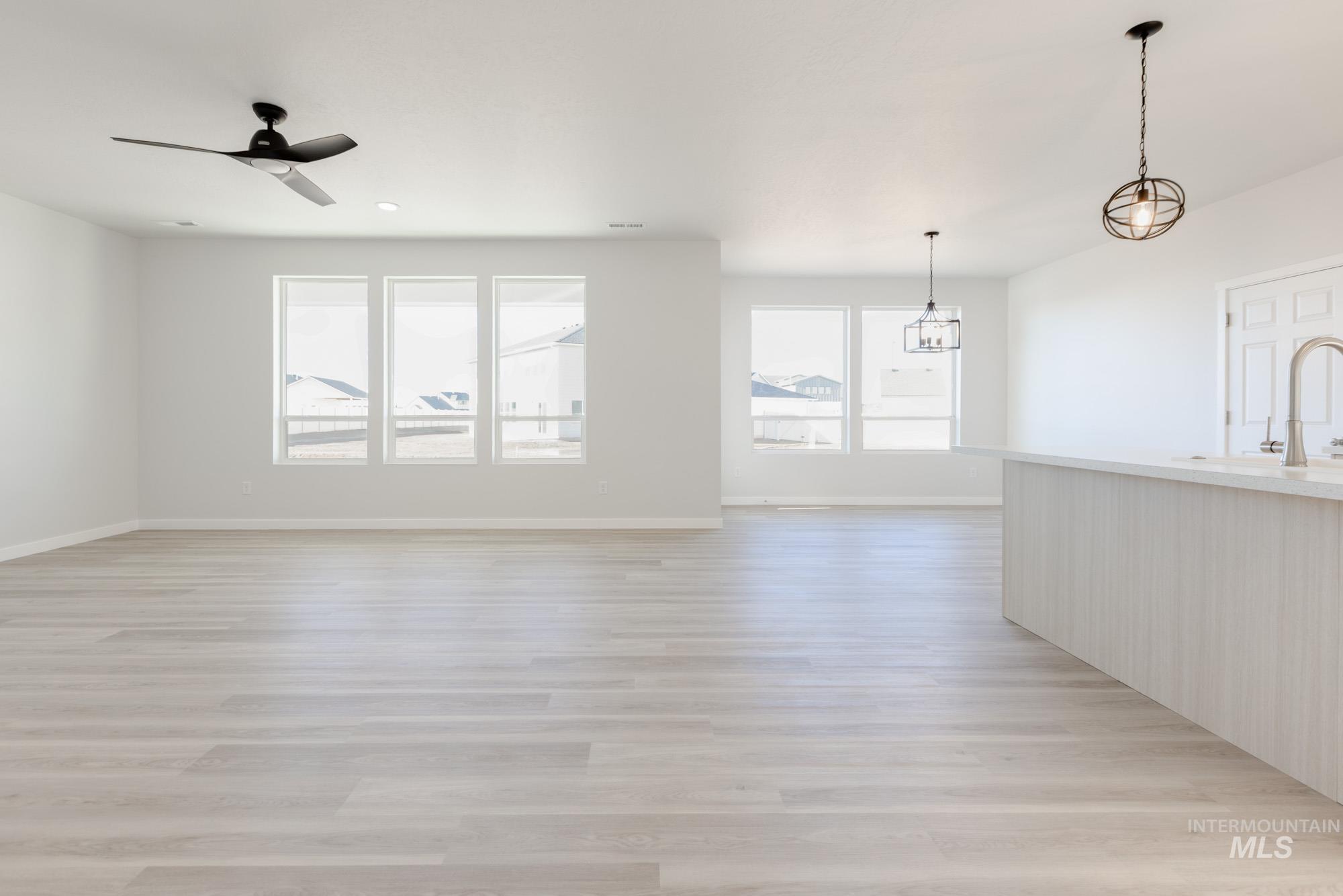 1639 Celina Street Middleton, ID 83644 - Photo 4 of 19 Spacious open-concept living area featuring light wood-finish flooring and multiple windows