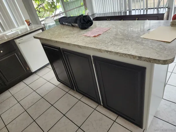 a kitchen with a sink a counter top space and cabinets