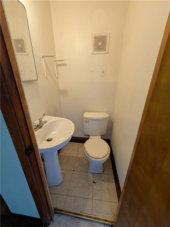 709-711 Fruit Way McKees Rocks, PA 15136 - Photo 31 of 37 a bathroom with a toilet and a sink