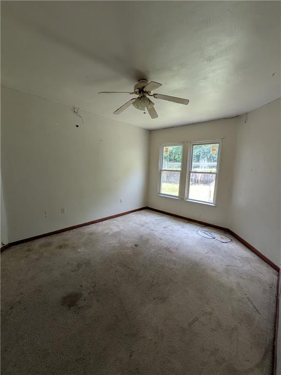 709-711 Fruit Way McKees Rocks, PA 15136 - Photo 36 of 37 an empty room with a window and a ceiling fan